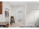 Hallway featuring view into laundry room with wooden shelf to the side at 4818 Winthrop Ave, Indianapolis, IN 46205