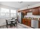 Efficient kitchen featuring stainless steel appliances, granite countertops, and a cozy dining area at 4818 Winthrop Ave, Indianapolis, IN 46205