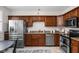 Functional kitchen with stainless steel appliances and warm wood cabinetry at 4818 Winthrop Ave, Indianapolis, IN 46205