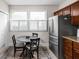 Kitchen features stainless steel refrigerator, adjacent to a dining area with shuttered windows at 4818 Winthrop Ave, Indianapolis, IN 46205