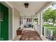 Inviting front porch featuring a charming porch swing and cozy outdoor decor at 4818 Winthrop Ave, Indianapolis, IN 46205