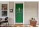 Close-up of a charming porch with a bright green door and decorative accents at 4818 Winthrop Ave, Indianapolis, IN 46205