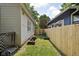 Grassy side yard with a wooden fence and raised garden beds at 4818 Winthrop Ave, Indianapolis, IN 46205