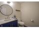 Bathroom with a stylish vanity, modern faucet, and round mirror at 4949 Jennings Dr, Carmel, IN 46033