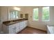 Bathroom featuring a double sink vanity with wood floors and natural light at 4949 Jennings Dr, Carmel, IN 46033