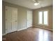 Bright bedroom with hardwood floors, two closets and a window at 4949 Jennings Dr, Carmel, IN 46033