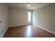 Cozy bedroom with wood flooring, a ceiling fan, and natural light at 4949 Jennings Dr, Carmel, IN 46033