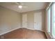 Bedroom with wood floors, two closets, and large window at 4949 Jennings Dr, Carmel, IN 46033