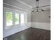 Well-lit dining room with hardwood floors, detailed trim, and a large window at 4949 Jennings Dr, Carmel, IN 46033