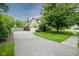 Beautifully landscaped home with mature trees and a long driveway at 4949 Jennings Dr, Carmel, IN 46033