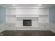 White brick fireplace with shelving and cabinets, perfect for storage and displaying decor at 4949 Jennings Dr, Carmel, IN 46033