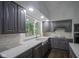 Modern kitchen with granite countertops, white subway tile, and a view of the outdoors at 4949 Jennings Dr, Carmel, IN 46033
