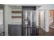 Modern kitchen features stainless steel refrigerator with white subway tile and wood shelves at 4949 Jennings Dr, Carmel, IN 46033