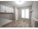 Functional laundry room with ample storage, a window, and tile flooring at 4949 Jennings Dr, Carmel, IN 46033