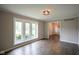 Bright living room with hardwood floors and a large window allowing for plenty of natural light at 4949 Jennings Dr, Carmel, IN 46033