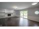 Spacious living room featuring hardwood floors, a brick fireplace, and sliding glass doors at 4949 Jennings Dr, Carmel, IN 46033