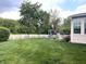 Spacious backyard with a white picket fence, a playset, and plenty of room to play at 5010 Cabrillo Dr, Plainfield, IN 46168