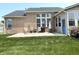 Brick house's backyard patio with chairs, grill, outdoor umbrella and well-kept lawn at 5010 Cabrillo Dr, Plainfield, IN 46168