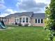 Lush backyard with green grass, a patio area, and a play set perfect for outdoor enjoyment at 5010 Cabrillo Dr, Plainfield, IN 46168