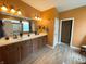 Spacious bathroom with double vanity sinks, wood floors and modern fixtures at 5010 Cabrillo Dr, Plainfield, IN 46168