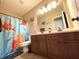 Functional bathroom featuring a double vanity and bright shower curtain at 5010 Cabrillo Dr, Plainfield, IN 46168