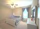 Comfortable bedroom with ceiling fan, queen bed, side tables, dresser and neutral carpet at 5010 Cabrillo Dr, Plainfield, IN 46168