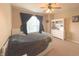 This bedroom features neutral walls, carpet, a white-painted bedframe, and a large window at 5010 Cabrillo Dr, Plainfield, IN 46168