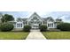 Community clubhouse entrance with manicured landscaping, gated access to the pool, and a welcoming facade at 5010 Cabrillo Dr, Plainfield, IN 46168