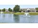 Community pool with fountain in a pond, lounge chairs, clubhouse, and parked cars at 5010 Cabrillo Dr, Plainfield, IN 46168