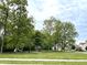 Neighborhood green space with mature trees, gazebo, and playground creating a relaxed area for residents at 5010 Cabrillo Dr, Plainfield, IN 46168