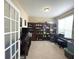 Cozy office space with large built-in bookshelves and a piano at 5010 Cabrillo Dr, Plainfield, IN 46168