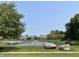 Scenic view of a pond surrounded by lush landscaping and nearby residential homes at 5010 Cabrillo Dr, Plainfield, IN 46168