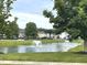 Community pond with fountain feature and lush landscaping creating a serene and picturesque view for the neighborhood at 5010 Cabrillo Dr, Plainfield, IN 46168