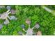 Lush, green aerial view of houses nestled among mature trees creating a peaceful neighborhood setting at 5558 Spicebush Dr, Indianapolis, IN 46254