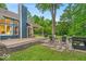Charming backyard with a stone patio, fire pit, and a covered deck for relaxation and entertainment at 5558 Spicebush Dr, Indianapolis, IN 46254