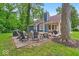 Spacious backyard with a patio, fire pit, seating area, and lush greenery at 5558 Spicebush Dr, Indianapolis, IN 46254