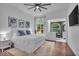 Bright bedroom with a view to the ensuite bathroom and decorative artwork above the bed at 5558 Spicebush Dr, Indianapolis, IN 46254