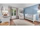 Well-appointed Bedroom with a comfortable chair, crib, and ample natural light at 5558 Spicebush Dr, Indianapolis, IN 46254