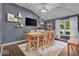 Spacious dining room with a long wooden table, modern lighting, and a view of the outdoors at 5558 Spicebush Dr, Indianapolis, IN 46254