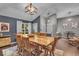 Elegant dining area with a large wooden table, seating for eight, and stylish overhead lighting at 5558 Spicebush Dr, Indianapolis, IN 46254