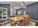 Bright dining area with an eight-seater wooden table, chic lighting, and a cozy seating area nearby at 5558 Spicebush Dr, Indianapolis, IN 46254