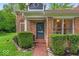 Charming front entrance with brick pathway, surrounded by manicured bushes and a classic brick facade at 5558 Spicebush Dr, Indianapolis, IN 46254