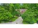 A red brick home with a blue garage door nestled among lush green trees and a well-maintained lawn at 5558 Spicebush Dr, Indianapolis, IN 46254