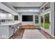 Open concept kitchen with white countertops, and stainless appliances, seamlessly flows into the living space at 5558 Spicebush Dr, Indianapolis, IN 46254