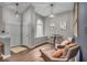 Bright and inviting living room featuring leather chairs, wood floors, and a cozy seating area near the entrance at 5558 Spicebush Dr, Indianapolis, IN 46254