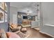 Open-concept living room with wood floors, comfortable seating, and a large dining table in the background at 5558 Spicebush Dr, Indianapolis, IN 46254