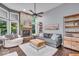 Cozy living room featuring a stone fireplace, high ceilings, and large windows for natural light at 5558 Spicebush Dr, Indianapolis, IN 46254