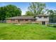 Wide backyard features green grass and the exterior of the home at 5631 N Olivia Dr, Alexandria, IN 46001