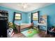 Bright bedroom features blue walls, hardwood floors, and ample storage space at 5631 N Olivia Dr, Alexandria, IN 46001