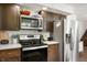 Modern kitchen with stainless steel appliances, ample cabinet space, and light countertops at 5631 N Olivia Dr, Alexandria, IN 46001